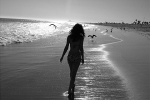 girl on beach with birds