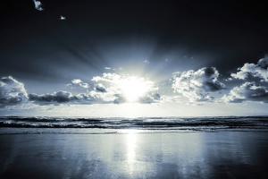 sun behind cloudes